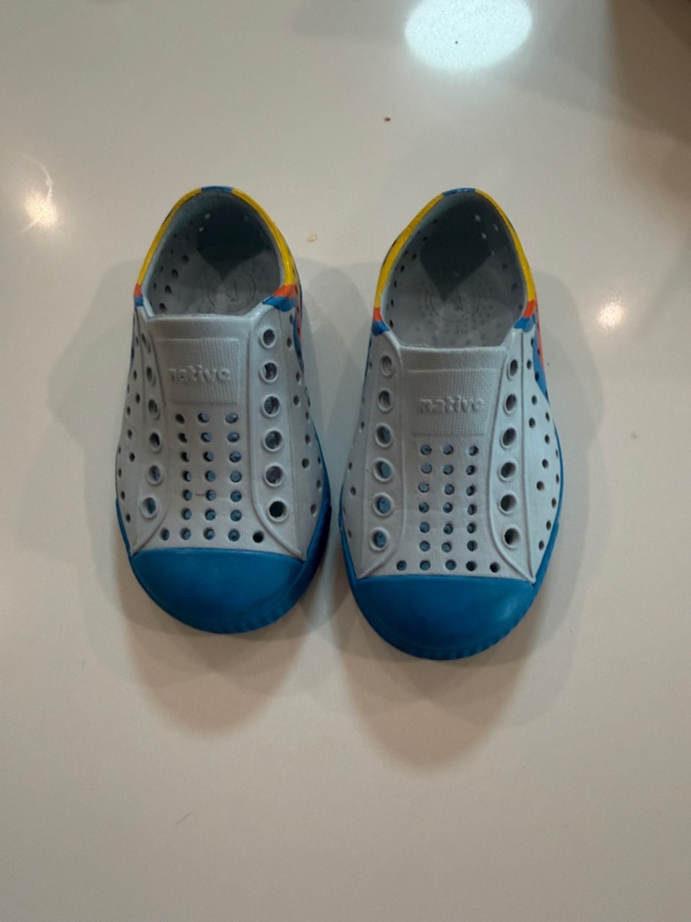 Native Kids White Slip-On Water Shoes with Blue Toe and Yellow Trim